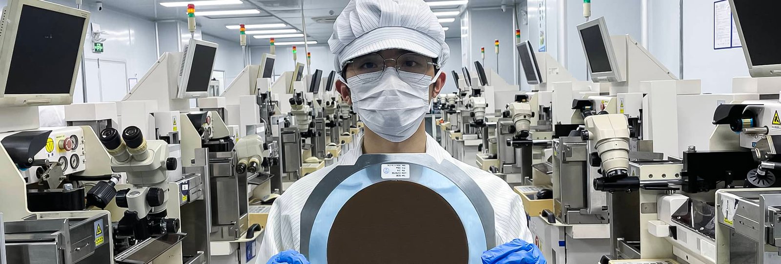 WF production base staff holding wafers